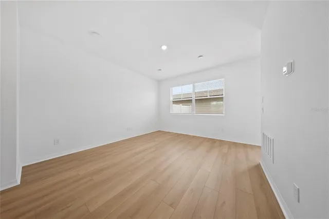 a view of a kitchen with a refrigerator and a stove top oven