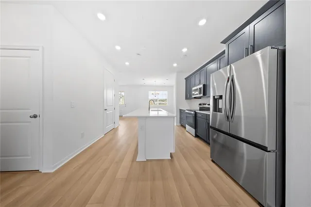 a view of empty room with wooden floor and windows