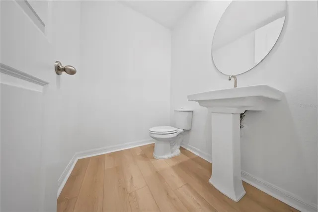 a bathroom with a sink toilet and a mirror