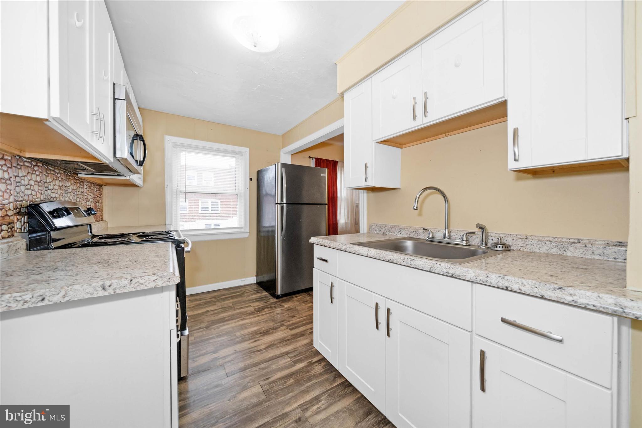 1950 Prospect Road Wilmington, DE 19805 - Photo 12 of 27 a kitchen with a sink stove and refrigerator