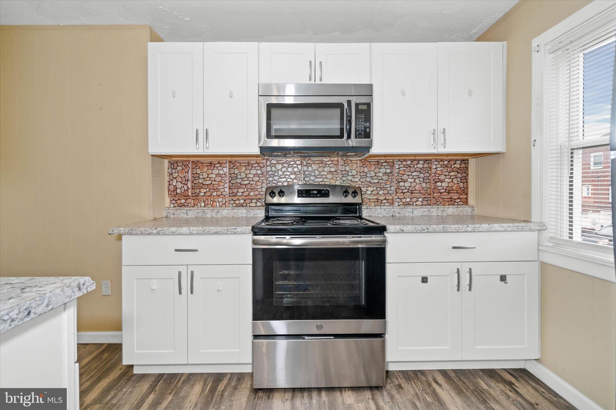 1950 Prospect Road Wilmington, DE 19805 - Photo 13 of 27 a kitchen with granite countertop white cabinets and stainless steel appliances