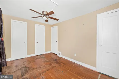 a view of a hallway with a ceiling fan