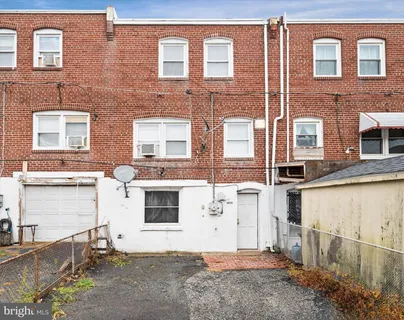 a view of a brick house with many windows
