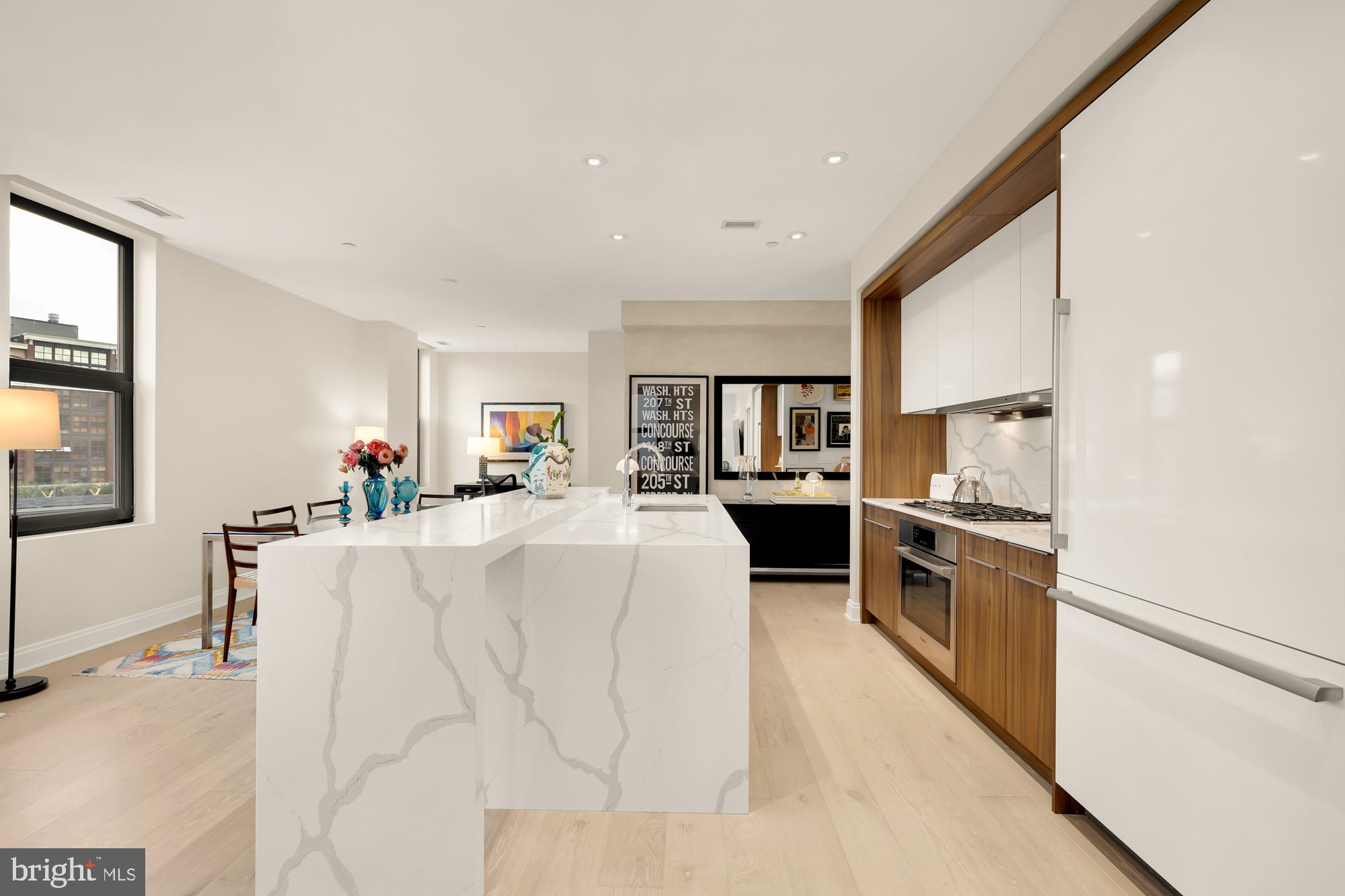 1427 Rhode Island Avenue Northwest, Unit 404 Washington, DC 20005 - Photo 13 of 35 a living room with stainless steel appliances furniture a flat screen tv and a refrigerator