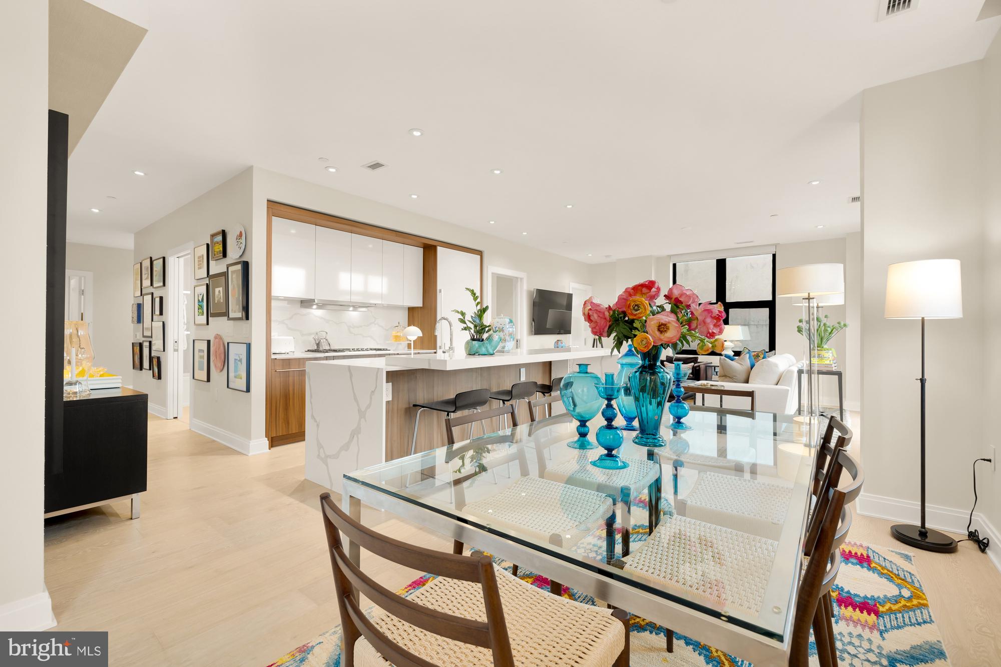 1427 Rhode Island Avenue Northwest, Unit 404 Washington, DC 20005 - Photo 16 of 35 a view of a dining room with furniture a potted plant and wooden floor