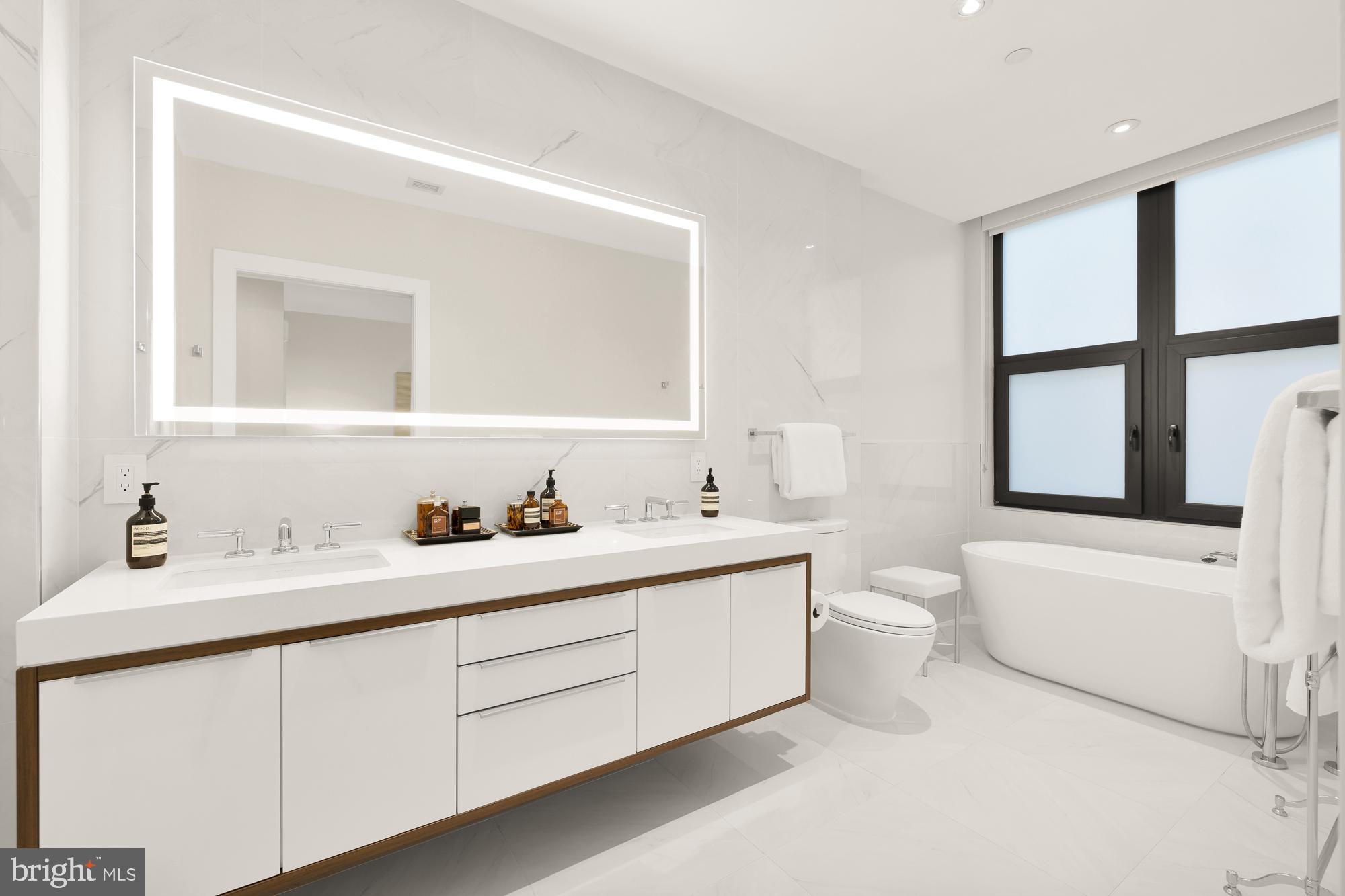 1427 Rhode Island Avenue Northwest, Unit 404 Washington, DC 20005 - Photo 20 of 35 a bathroom with a sink vanity mirror and toilet