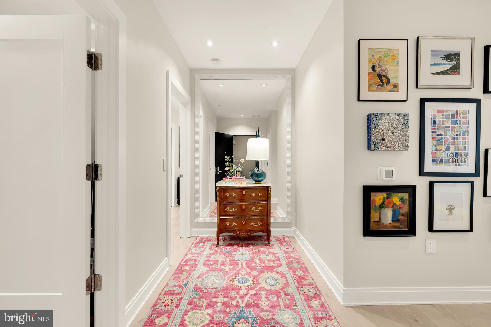 1427 Rhode Island Avenue Northwest, Unit 404 Washington, DC 20005 - Photo 2 of 35 a hallway with a dresser and mirror