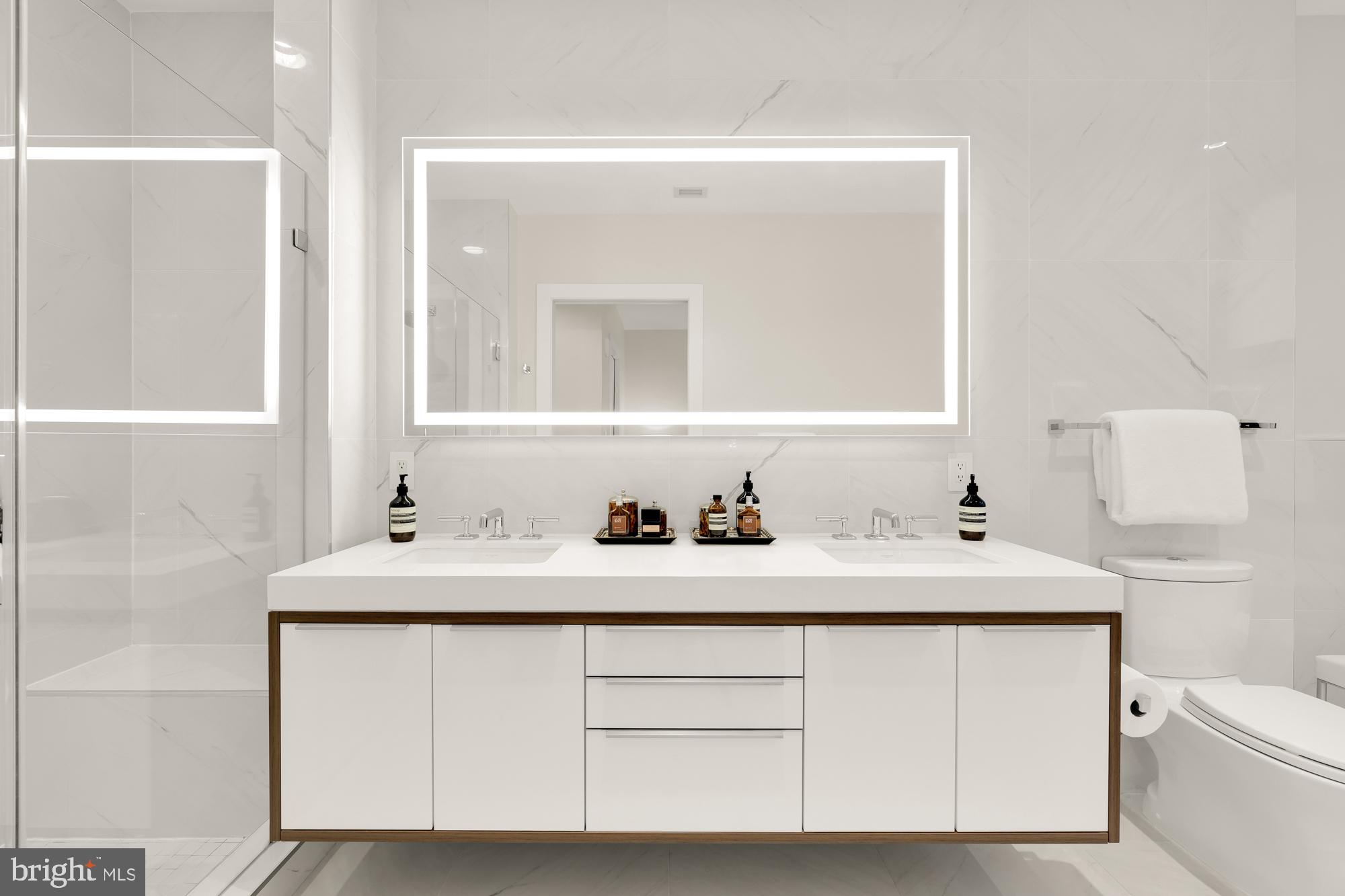 1427 Rhode Island Avenue Northwest, Unit 404 Washington, DC 20005 - Photo 21 of 35 a bathroom with a sink vanity and mirror