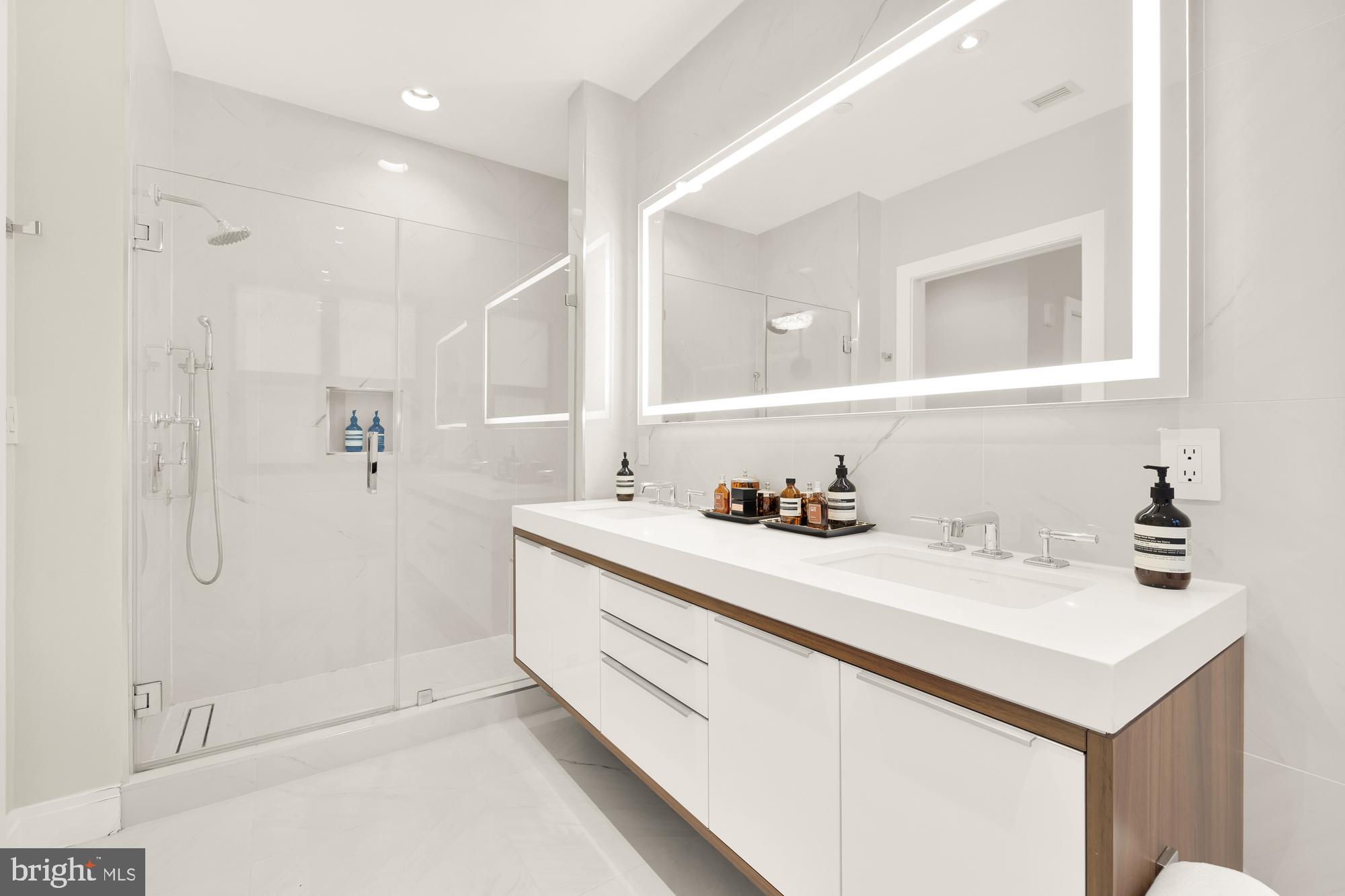 1427 Rhode Island Avenue Northwest, Unit 404 Washington, DC 20005 - Photo 22 of 35 a bathroom with a bathtub sink a mirror and shower