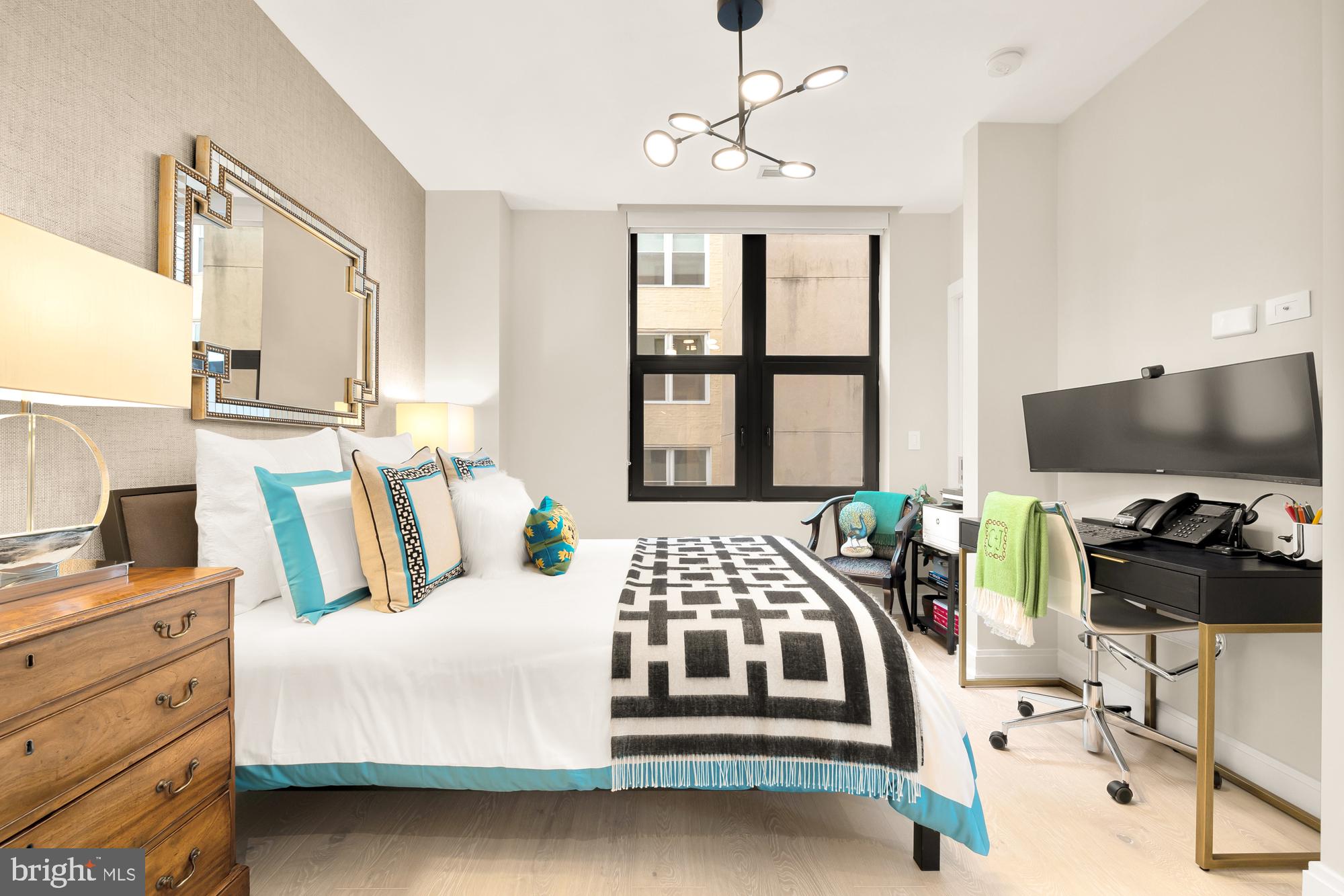 1427 Rhode Island Avenue Northwest, Unit 404 Washington, DC 20005 - Photo 25 of 35 a bedroom with a bed and a flat screen tv