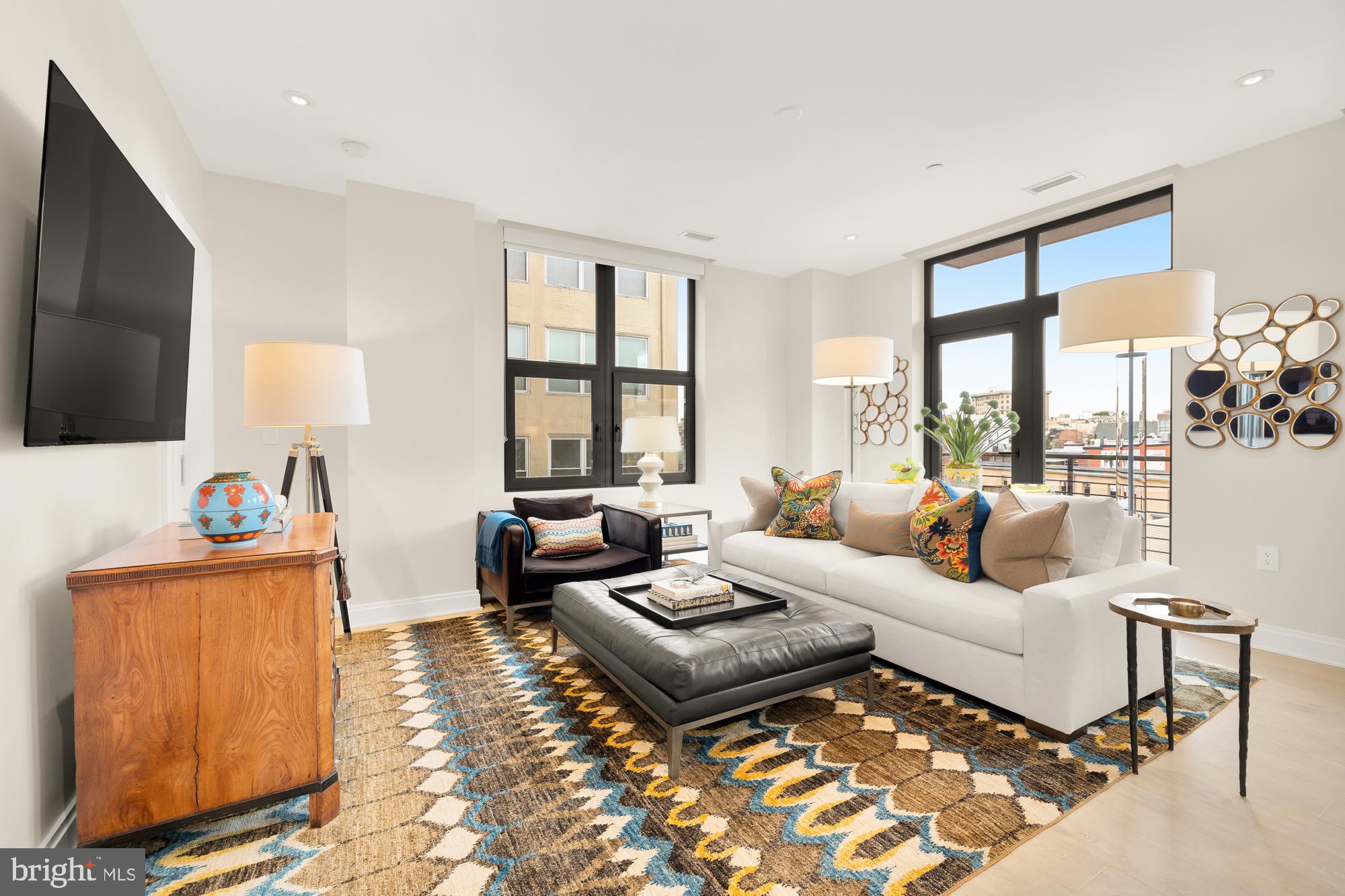 1427 Rhode Island Avenue Northwest, Unit 404 Washington, DC 20005 - Photo 5 of 35 a living room with furniture and a flat screen tv