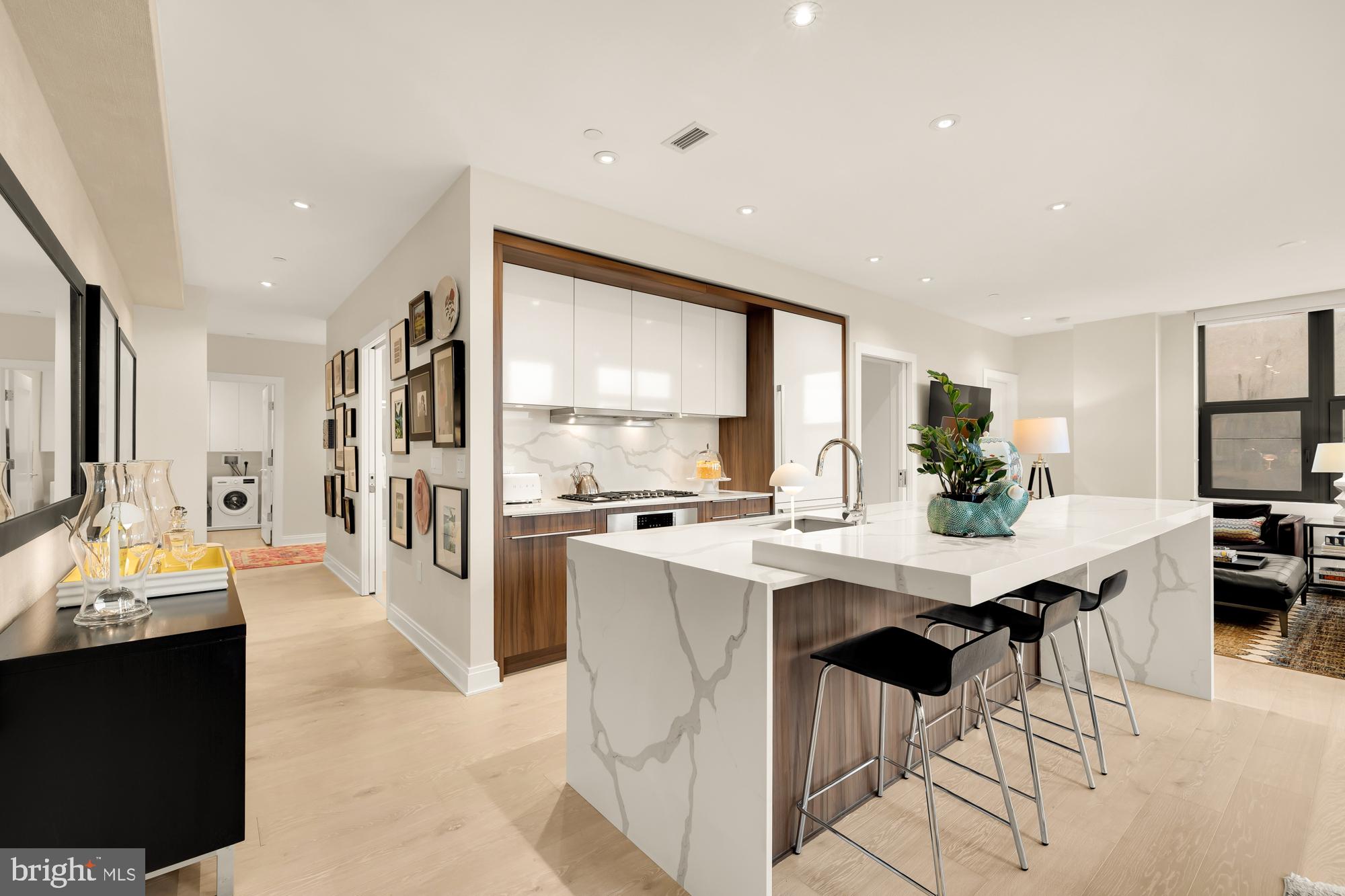 1427 Rhode Island Avenue Northwest, Unit 404 Washington, DC 20005 - Photo 8 of 35 a kitchen with stainless steel appliances kitchen island granite countertop a sink and cabinets