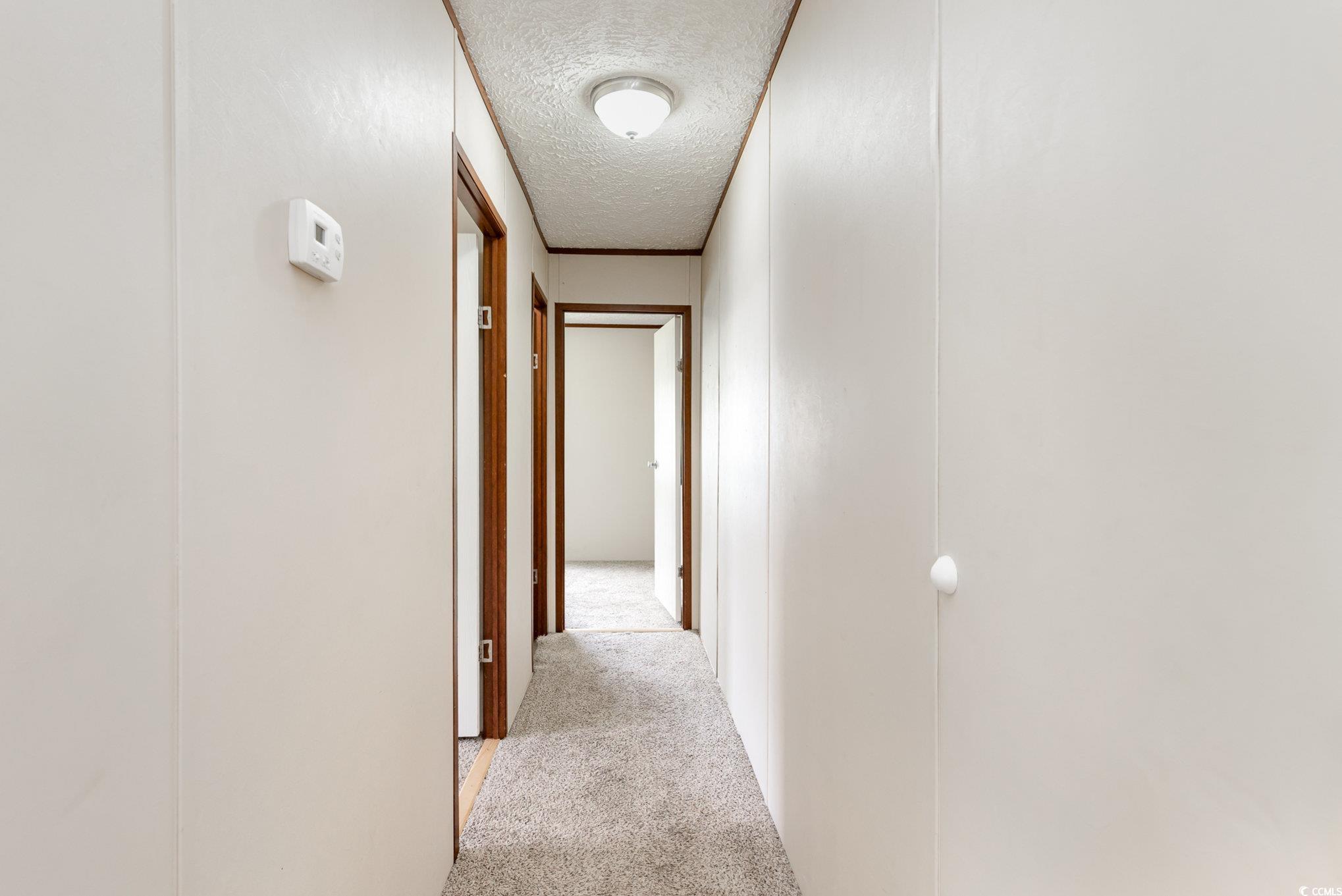 2100 Highway 15 Myrtle Beach, SC 29577 - Photo 20 of 35 Corridor featuring light carpet and a textured ceiling