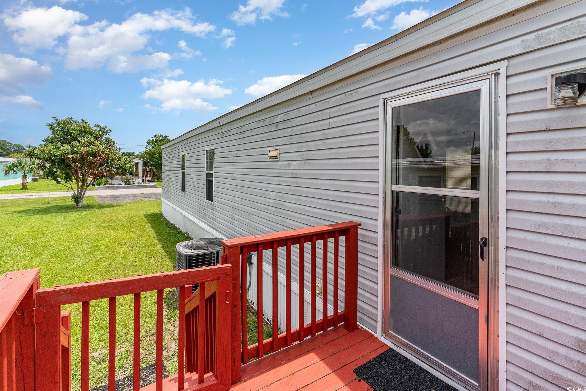 2100 Highway 15 Myrtle Beach, SC 29577 - Photo 2 of 35 Deck featuring central air condition unit and a yard