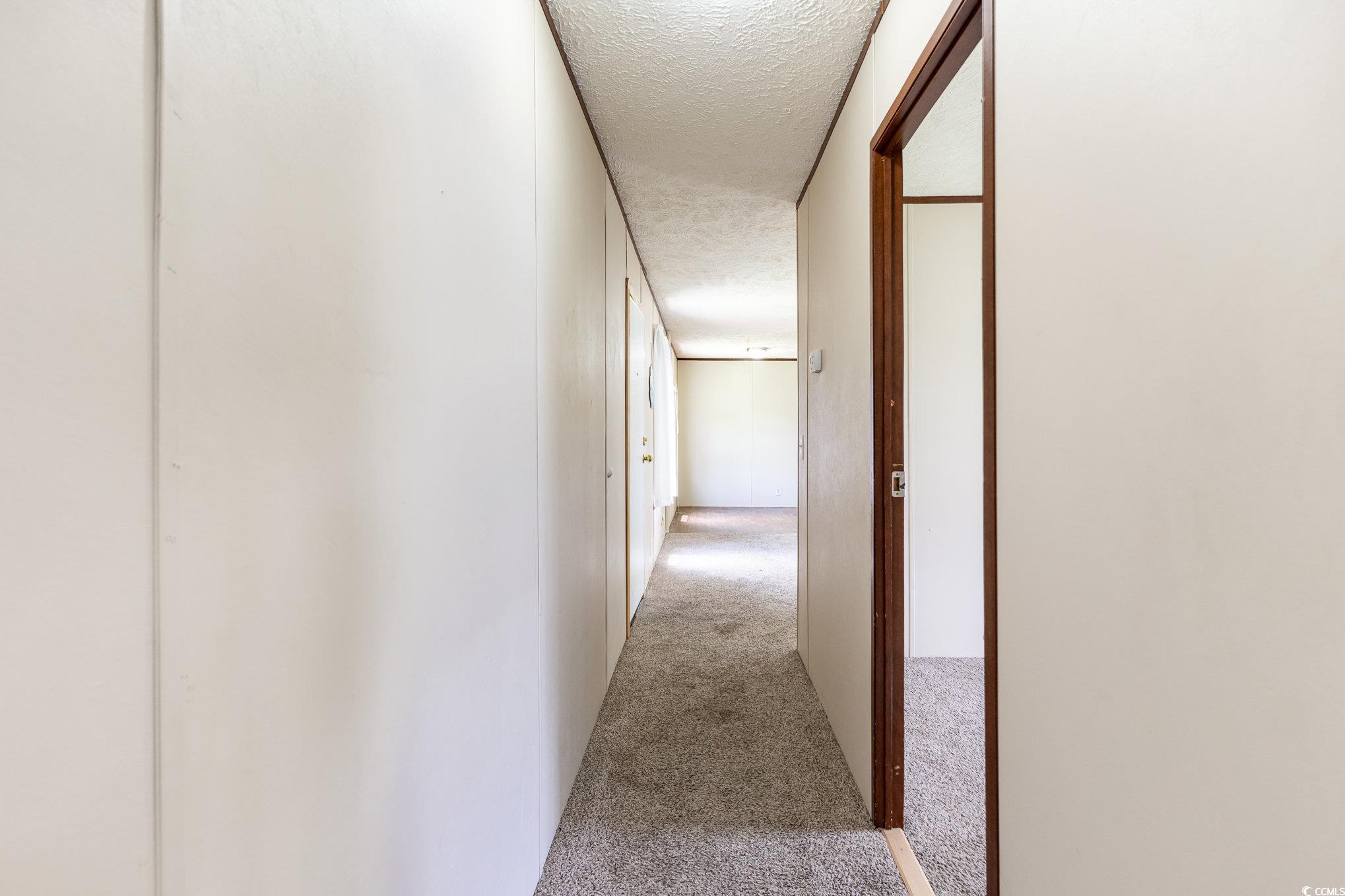 2100 Highway 15 Myrtle Beach, SC 29577 - Photo 21 of 35 Hall with a textured ceiling and carpet flooring