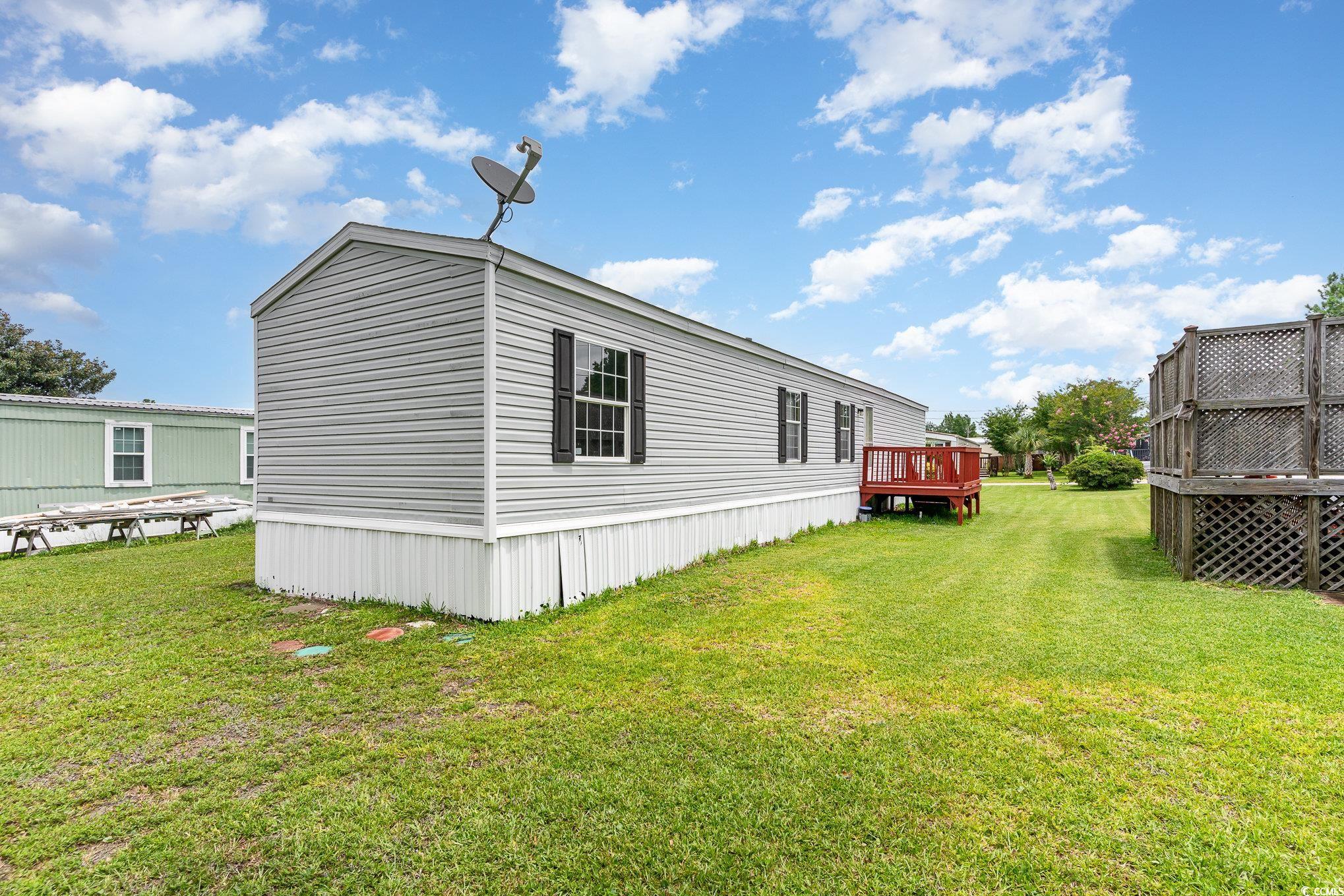 2100 Highway 15 Myrtle Beach, SC 29577 - Photo 24 of 35 View of side of home with a deck and a lawn