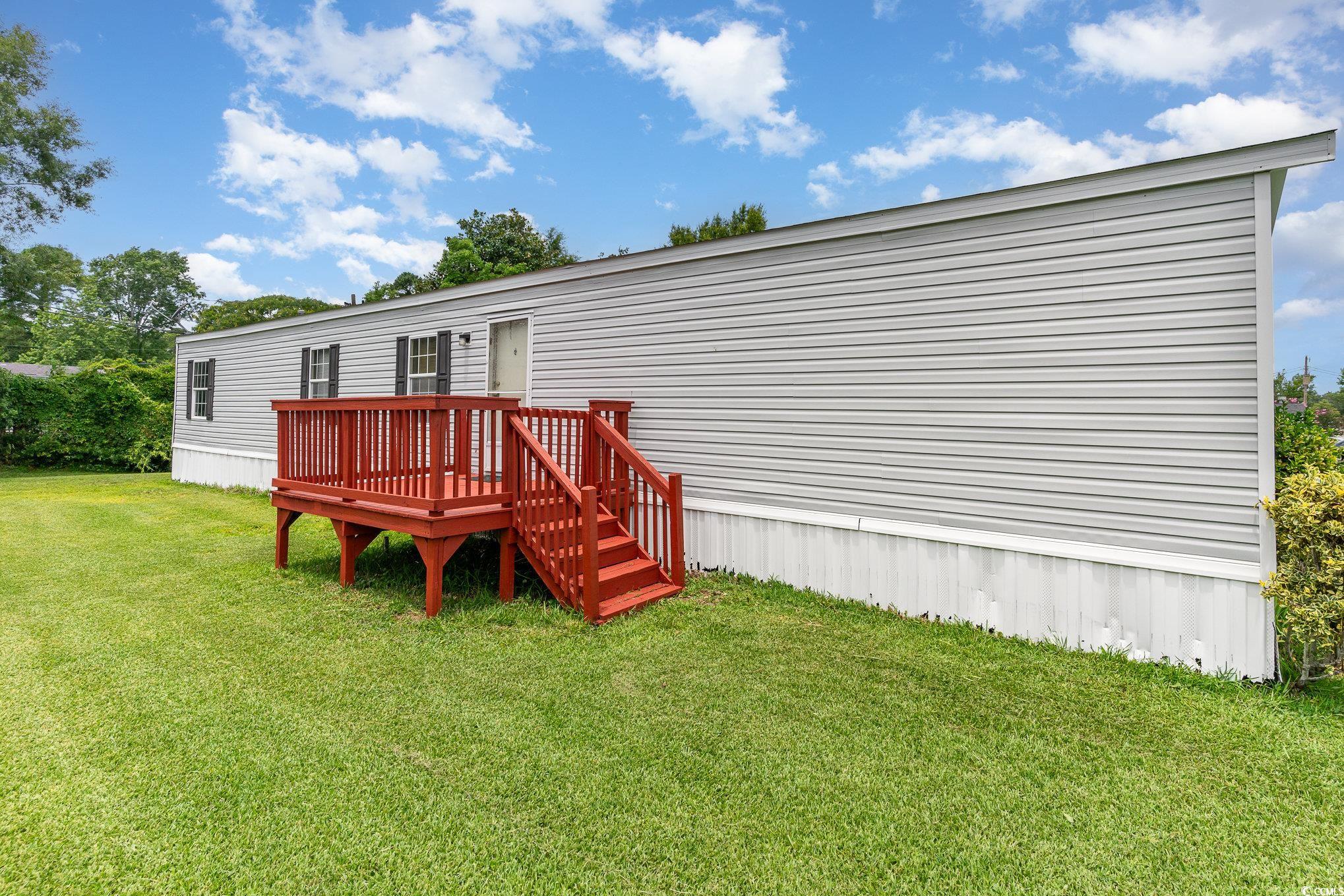 2100 Highway 15 Myrtle Beach, SC 29577 - Photo 27 of 35 Rear view of property featuring a deck and a yard