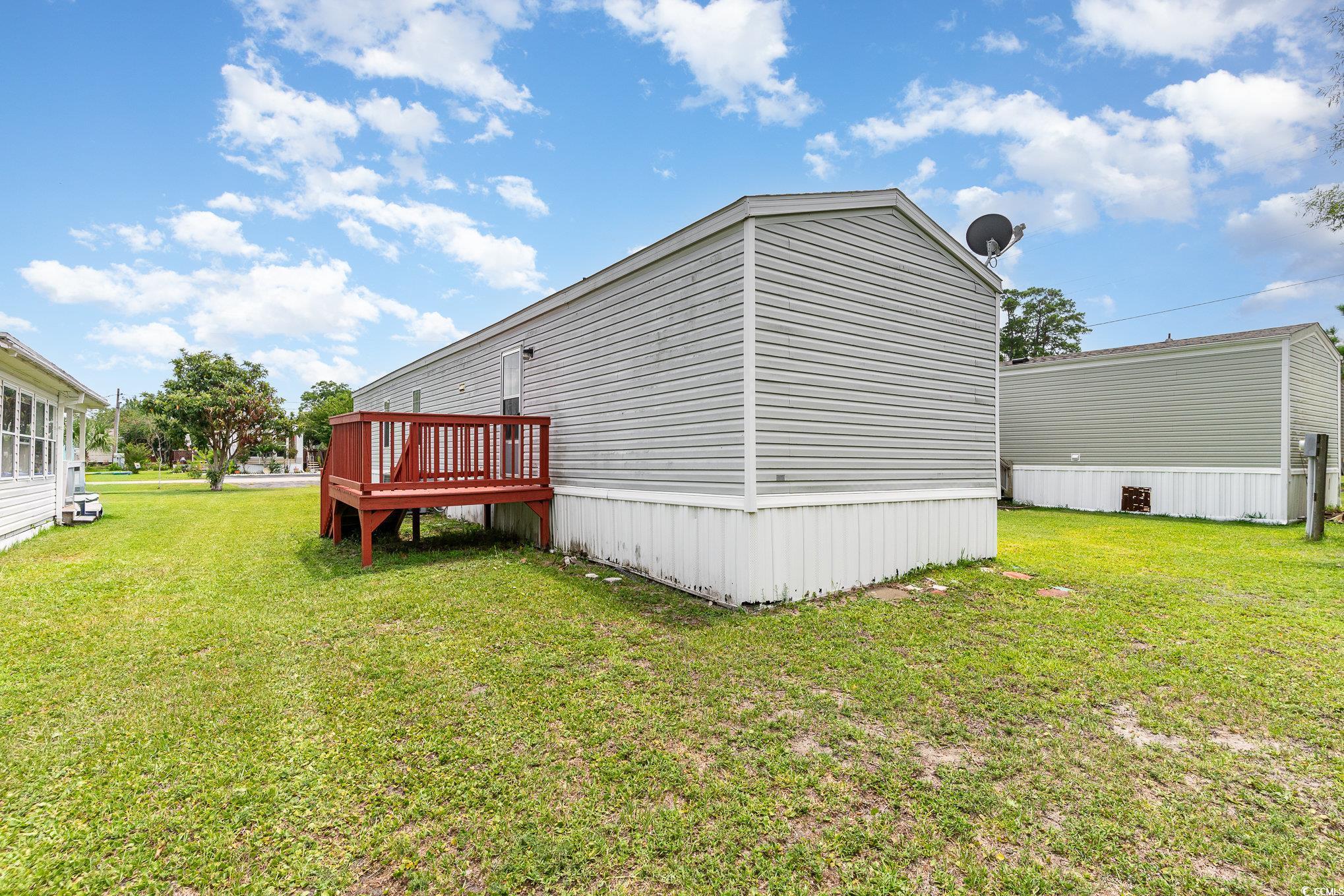 2100 Highway 15 Myrtle Beach, SC 29577 - Photo 28 of 35 View of side of home with a lawn and a wooden deck