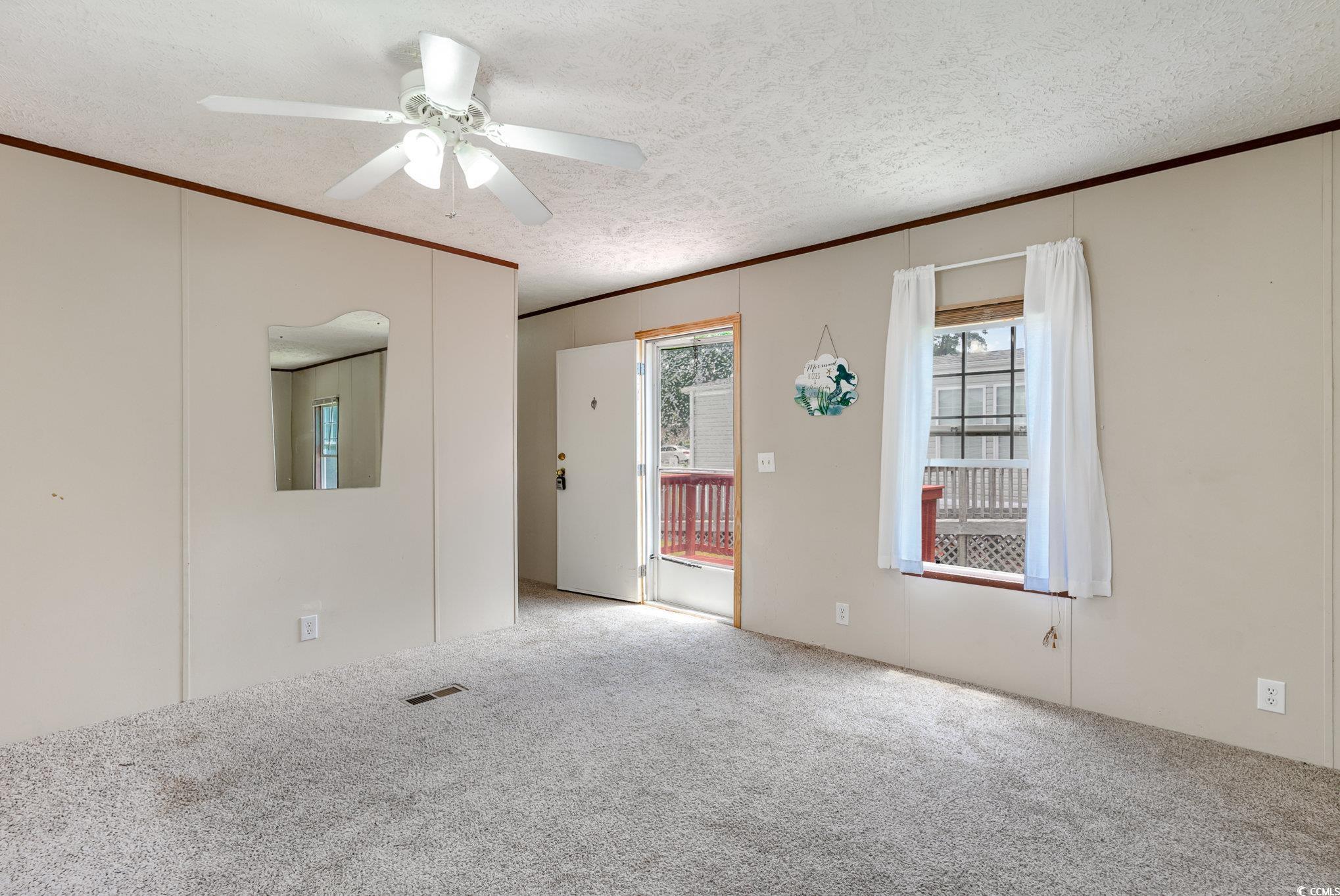 2100 Highway 15 Myrtle Beach, SC 29577 - Photo 6 of 35 Carpeted empty room featuring a textured ceiling, ornamental molding, and ceiling fan