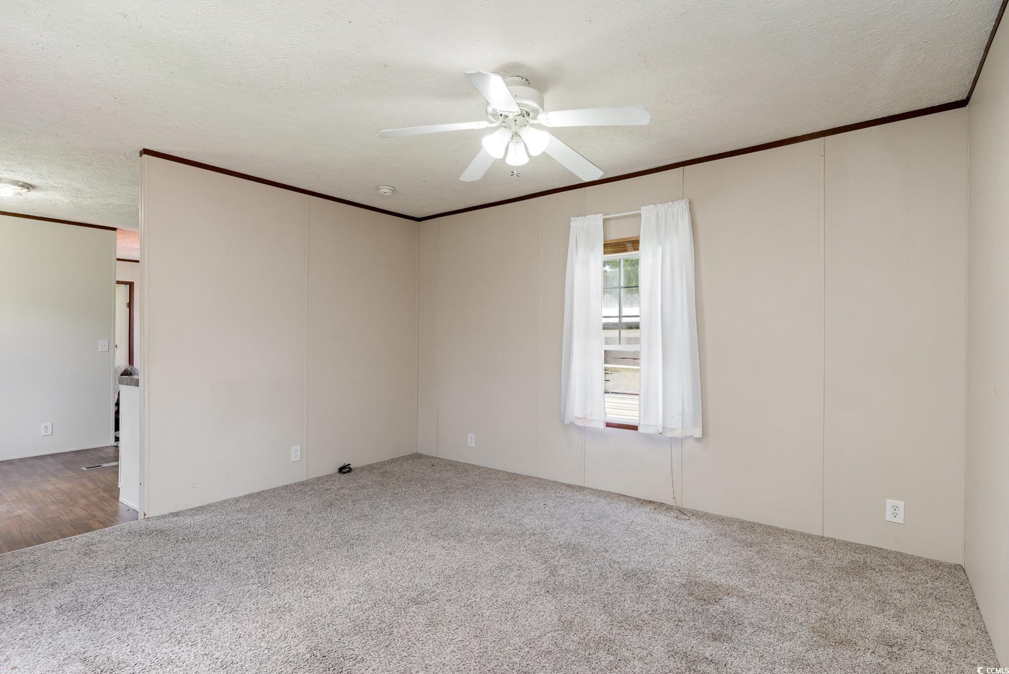 2100 Highway 15 Myrtle Beach, SC 29577 - Photo 8 of 35 Empty room featuring ornamental molding, carpet, a textured ceiling, and ceiling fan