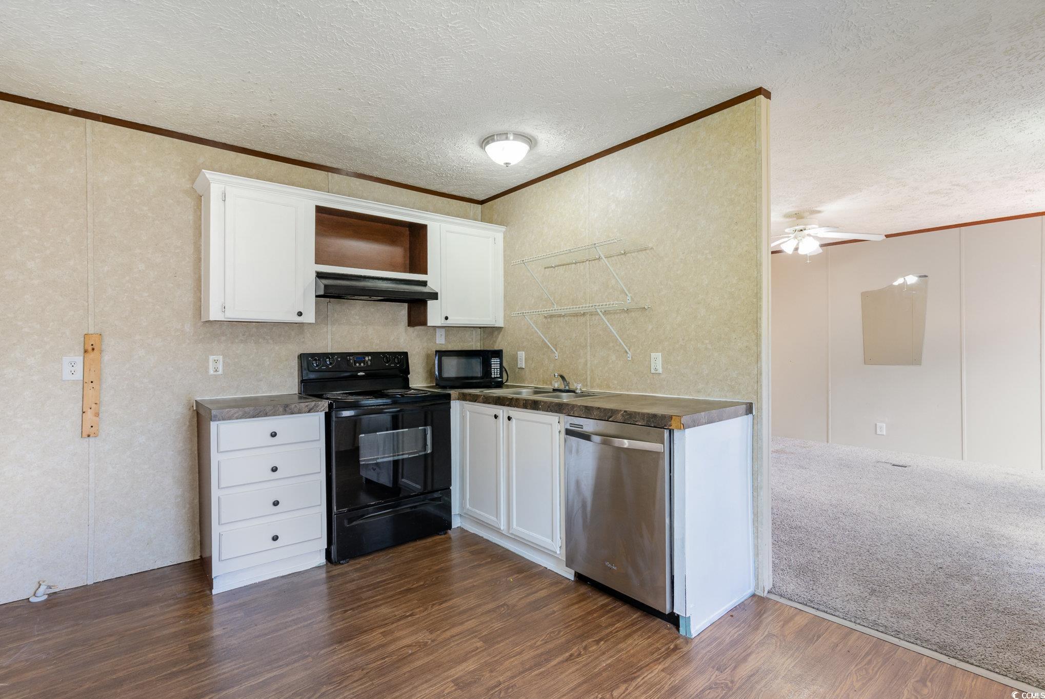 2100 Highway 15 Myrtle Beach, SC 29577 - Photo 9 of 35 Kitchen featuring black appliances, white cabinets, dark carpet, a textured ceiling, and ceiling fan