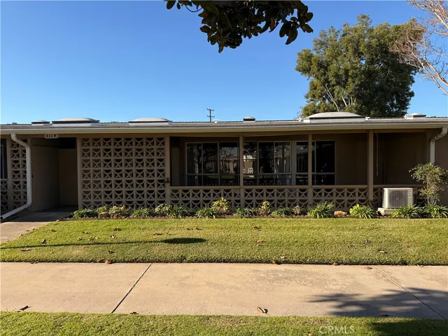 a view of a house with a yard in the background