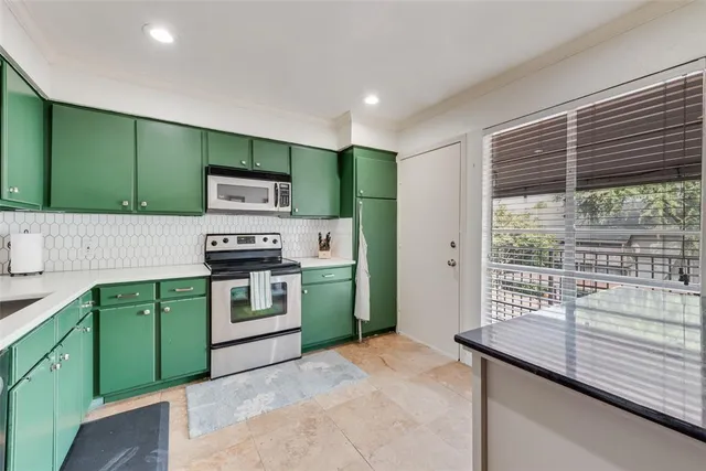 a kitchen with a refrigerator and a sink