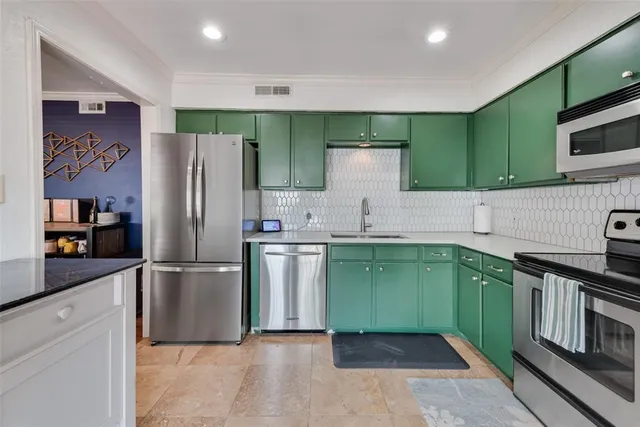 a kitchen with a refrigerator and a sink