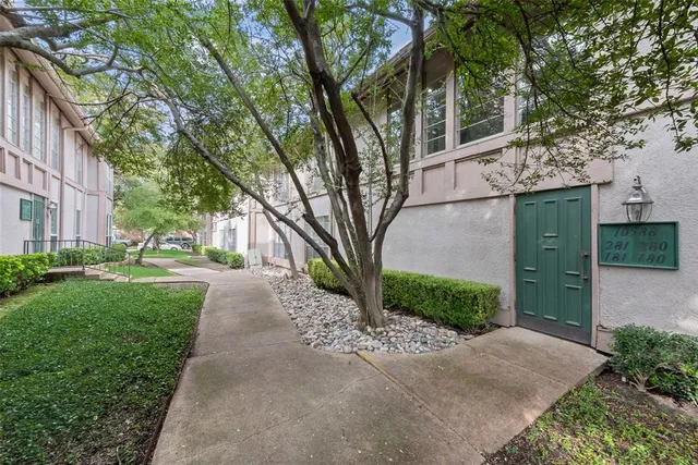 a pathway of a house with a yard
