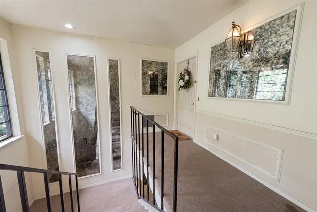 a view of a hallway with windows and entryway