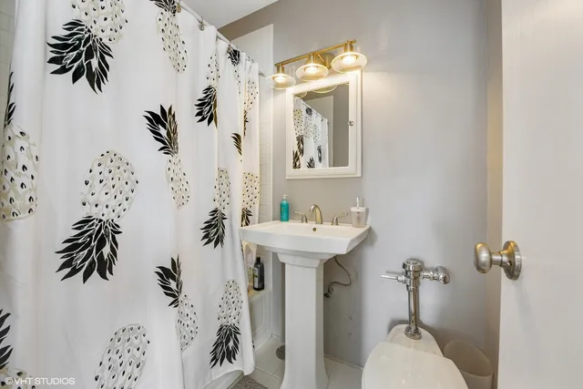 a bathroom with a sink and mirror with toilet