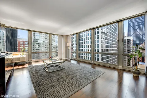 a living room with hardwood floor and a large window