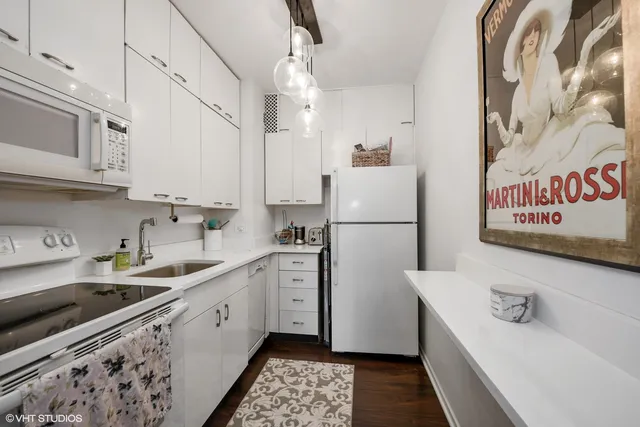 a kitchen with stainless steel appliances a refrigerator sink and cabinets