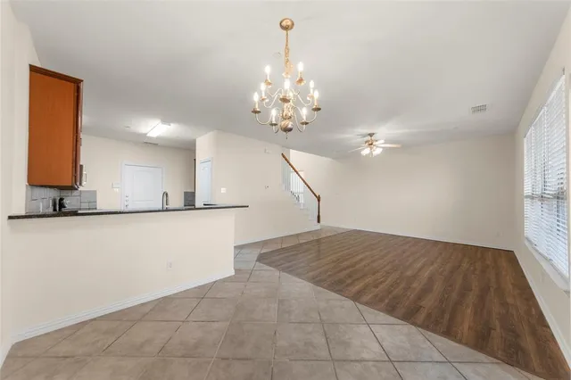 a kitchen with stainless steel appliances granite countertop wooden cabinets a sink and dishwasher