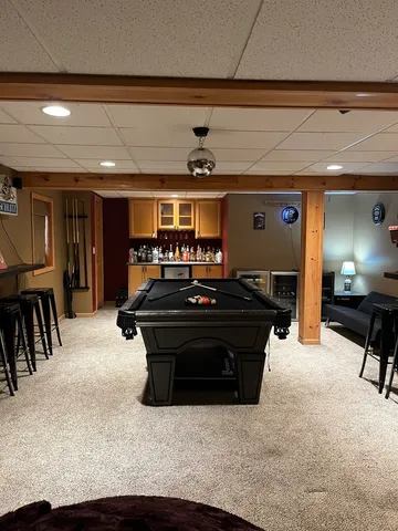 a living room with furniture and a piano