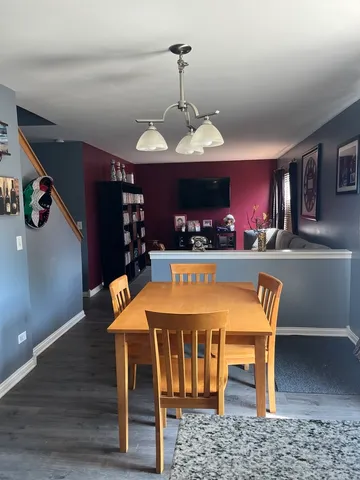 a dining room with furniture and wooden floor