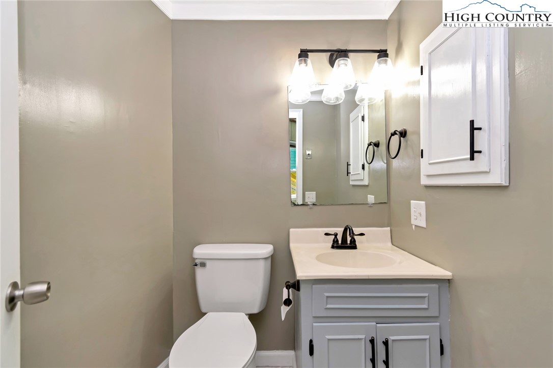 104 Hornbeam Road Beech Mountain, NC 28604 - Photo 16 of 40 a bathroom with a sink a toilet and a mirror