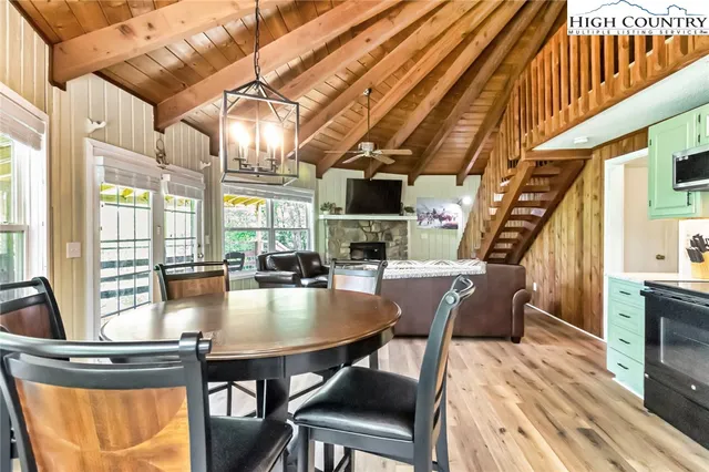 a dining room with furniture a chandelier and wooden floor
