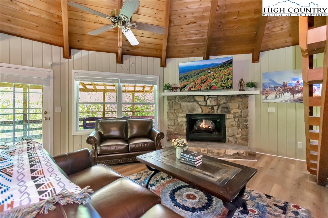 104 Hornbeam Road Beech Mountain, NC 28604 - Photo 22 of 40 a living room with furniture a fireplace and a table