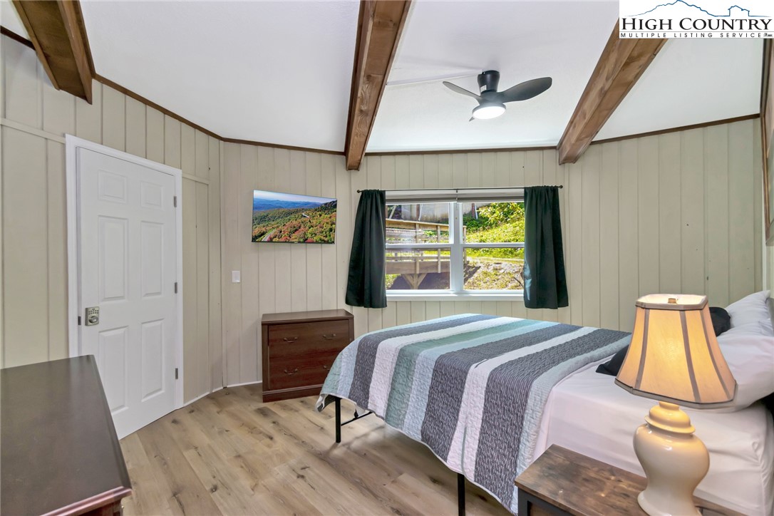 104 Hornbeam Road Beech Mountain, NC 28604 - Photo 34 of 40 a bedroom with a bed and wooden floor