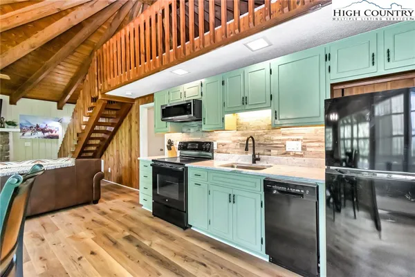 a view of a room with wooden floor