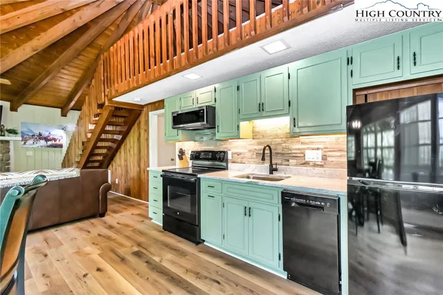 a view of a room with wooden floor