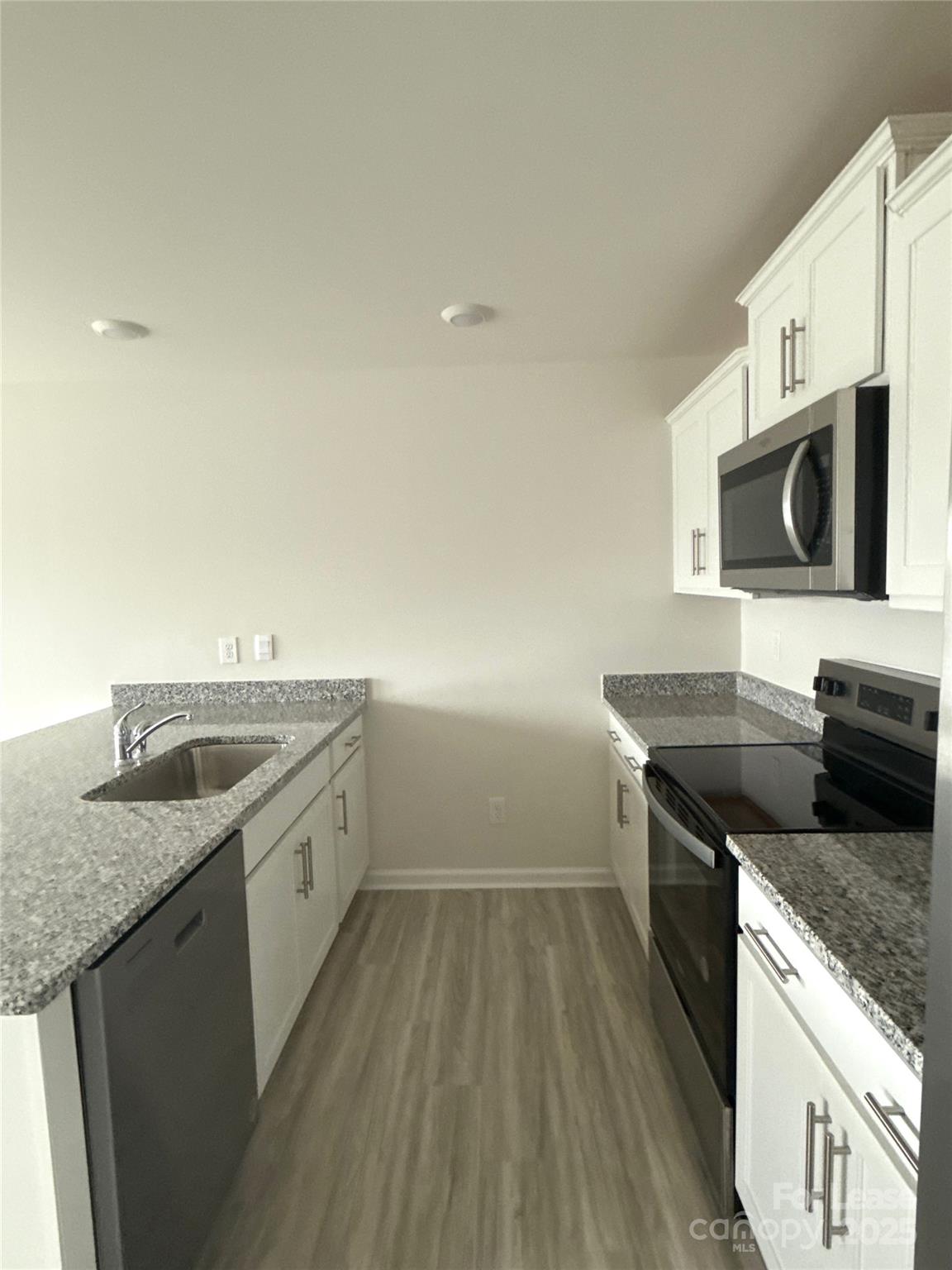 4148 Lurelin Road Charlotte, NC 28262 - Photo 4 of 12 a kitchen with a sink and a stove top oven