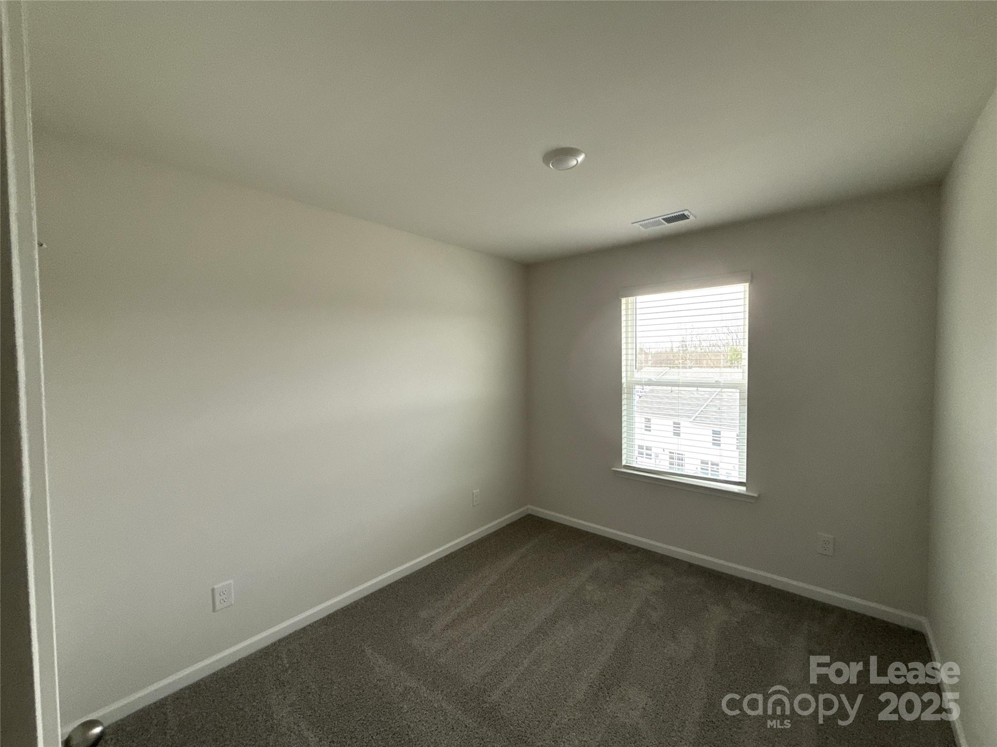 4148 Lurelin Road Charlotte, NC 28262 - Photo 8 of 12 an empty room with a window