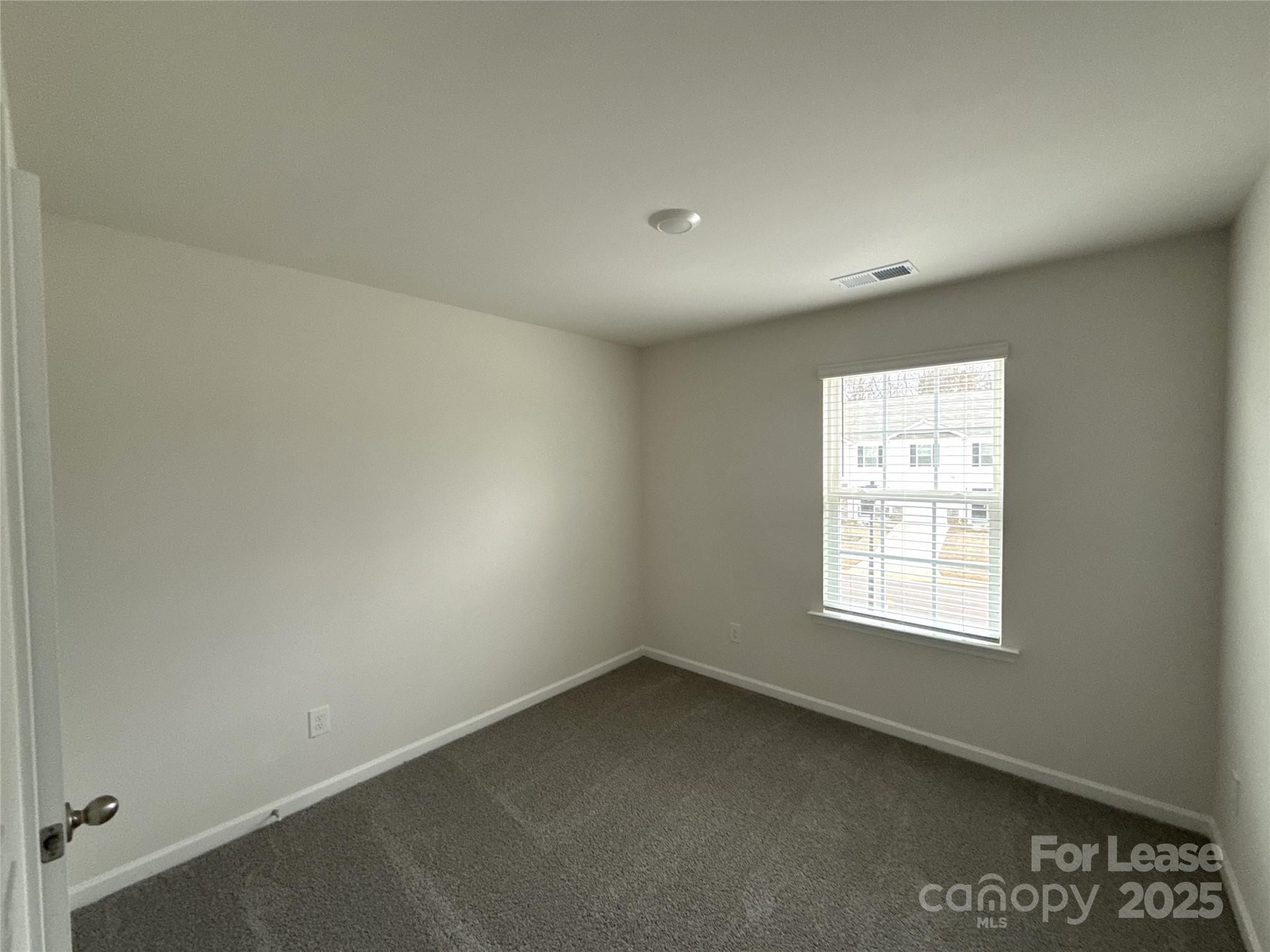 4148 Lurelin Road Charlotte, NC 28262 - Photo 9 of 12 an empty room with a window
