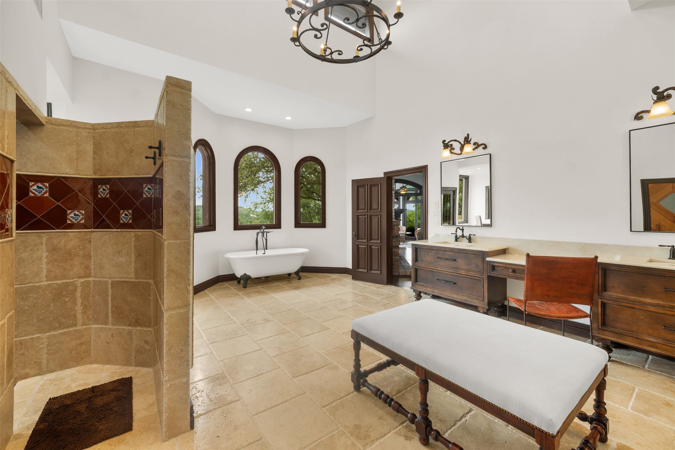 34000 Smithson Valley Road Bulverde, TX 78163 - Photo 19 of 50 Featuring dual vanities, custom cabinetry, a dedicated makeup station, and a spacious walk-in shower, the primary bath combines luxury and functionality. Architectural details and oversized windows enhance the room's grandeur.