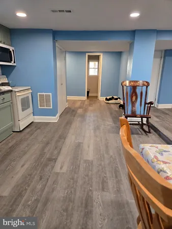 a kitchen with granite countertop a sink cabinets and stainless steel appliances