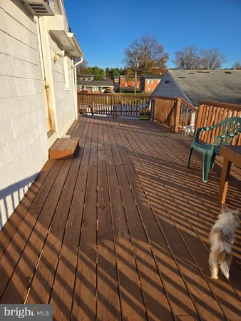 a balcony with table and chairs with wooden floor