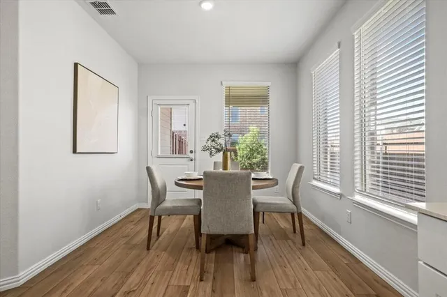 a dining room with furniture and wooden floor