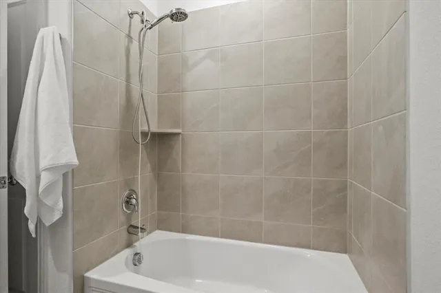 a bath tub sitting next to a white sink and vanity